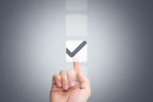 A hand touching a virtual checkbox with a checkmark, symbolizing selection, approval, or decision-making in a digital interface.